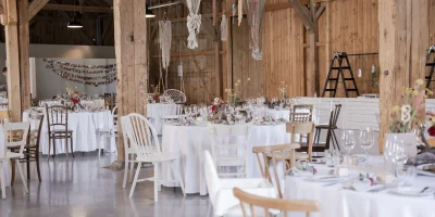 beautifully-decorated-wooden-wedding-area-with-white-covered-tables-_1_