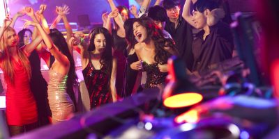 Chinese DJ doing record scratching in nightclub